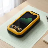 The Geiger counter lying on green graph paper, its screen showing a green trend line
